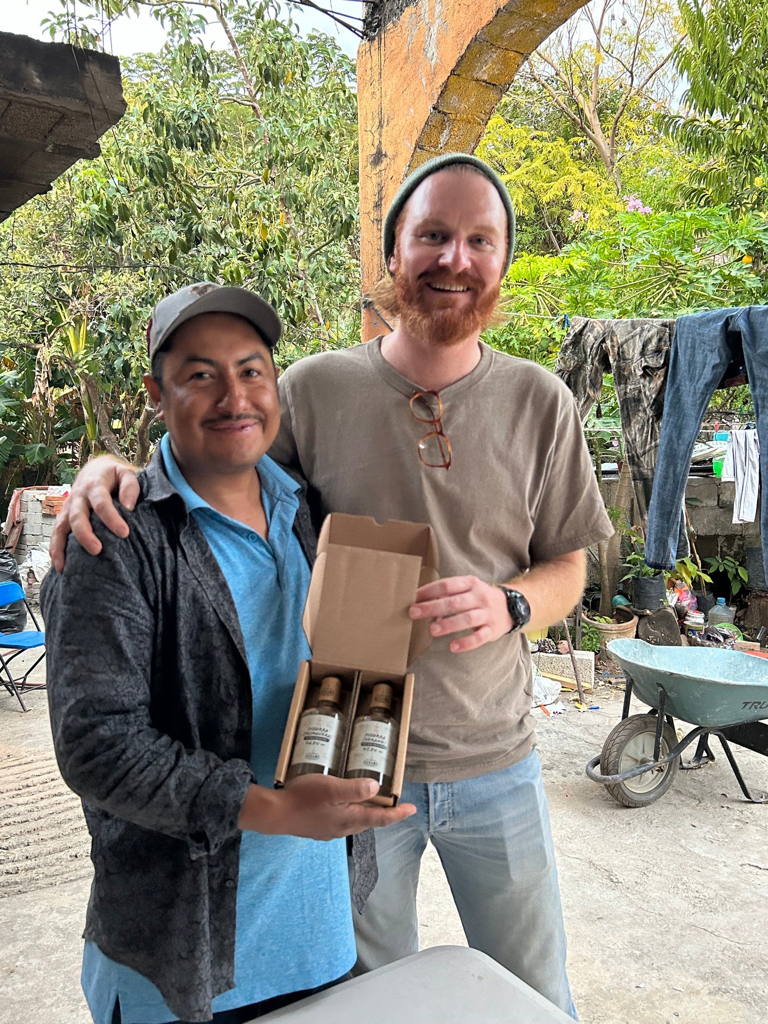 Delfino holding a bottle of Pizorra (Verano) - Ameyaltepec mezcal with Jon from the Sin Gusano project who exclusively stocks it