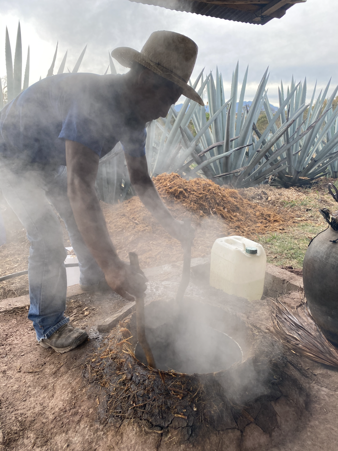 smoke coming from a still while making mezcal