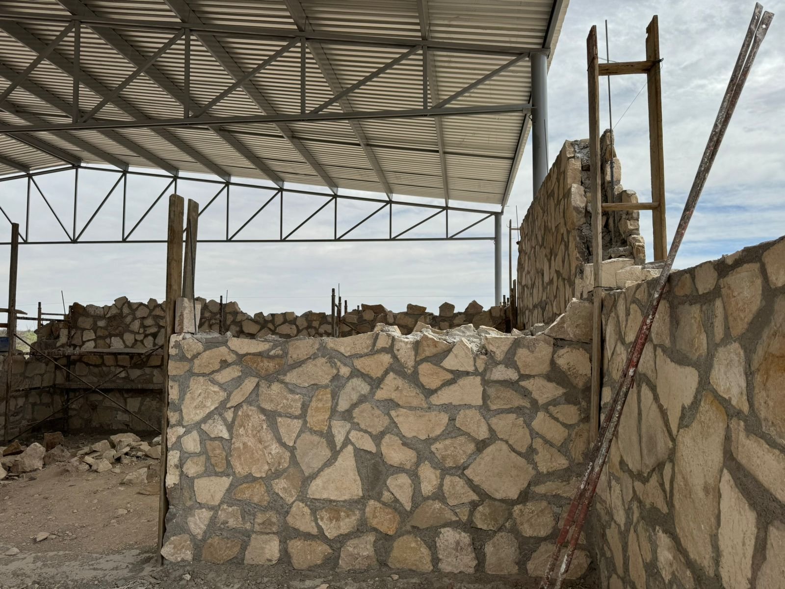 building the wall in the new distillery to make mezcal in Mexico