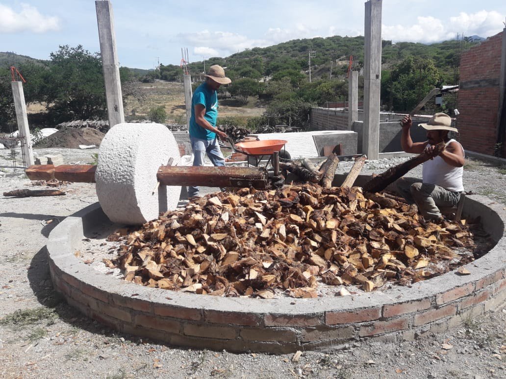 A brand new white stone tahona crushing roasted Madrecuishe
