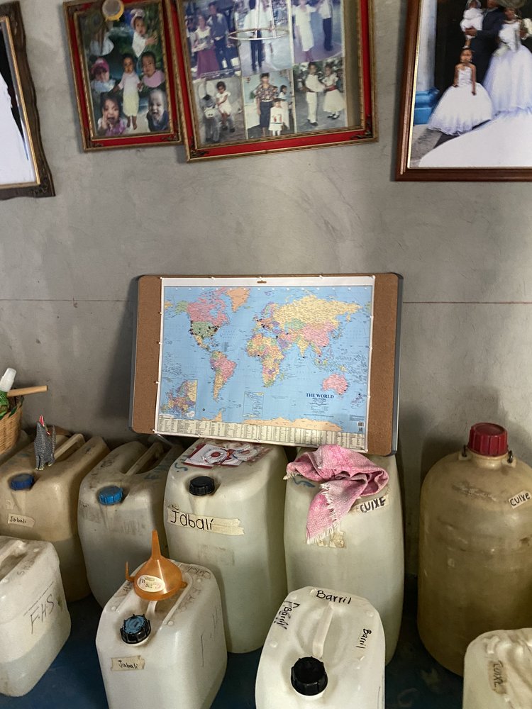 A world map sat on large plastic containers full of mezcal