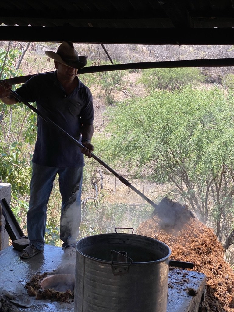 Swapping out the bagaso from the still during mezcal distillation
