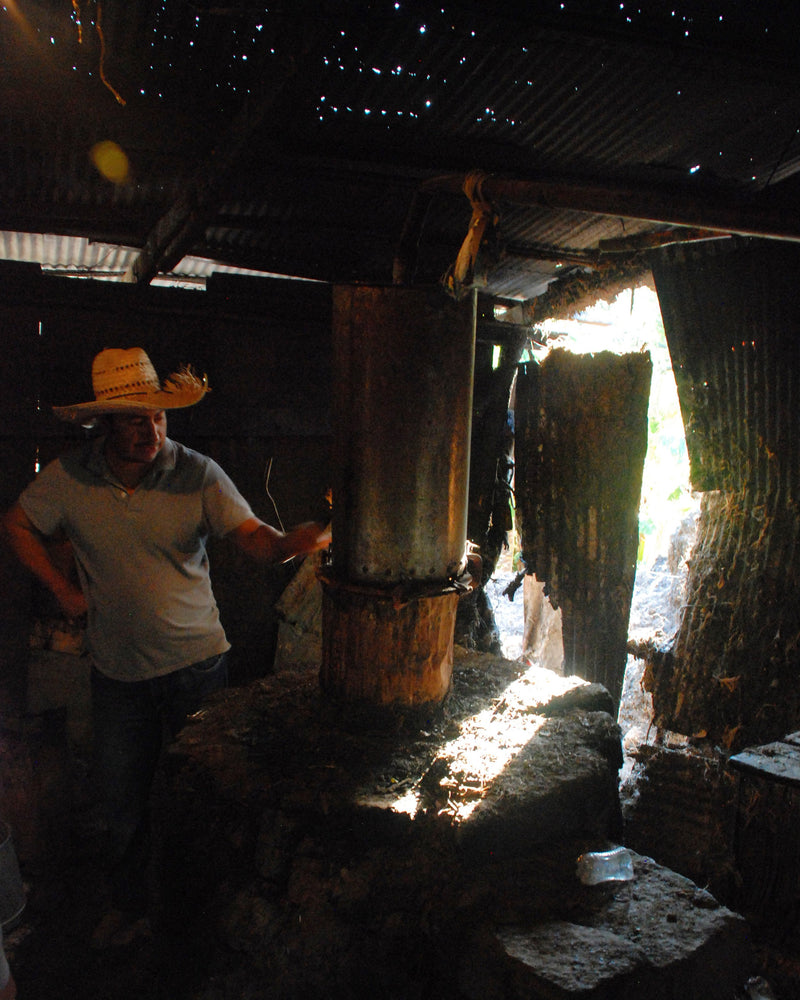 a copper pot still making mezcal traditionally
