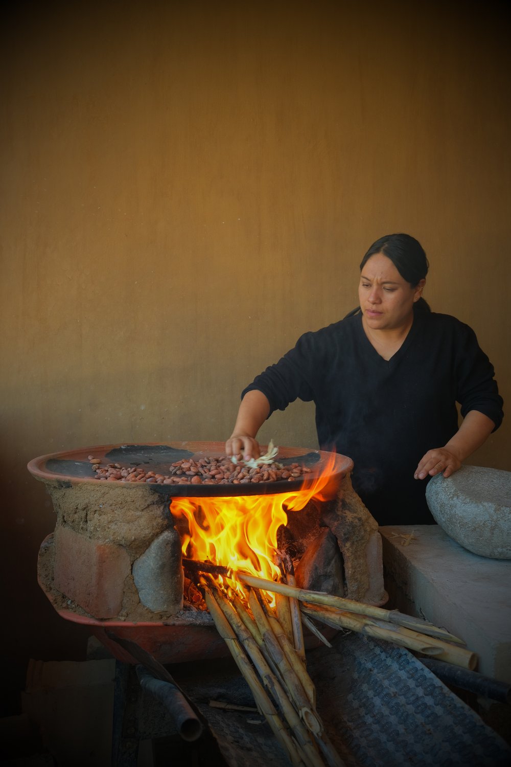 Rosario at the comal roasting cacao 