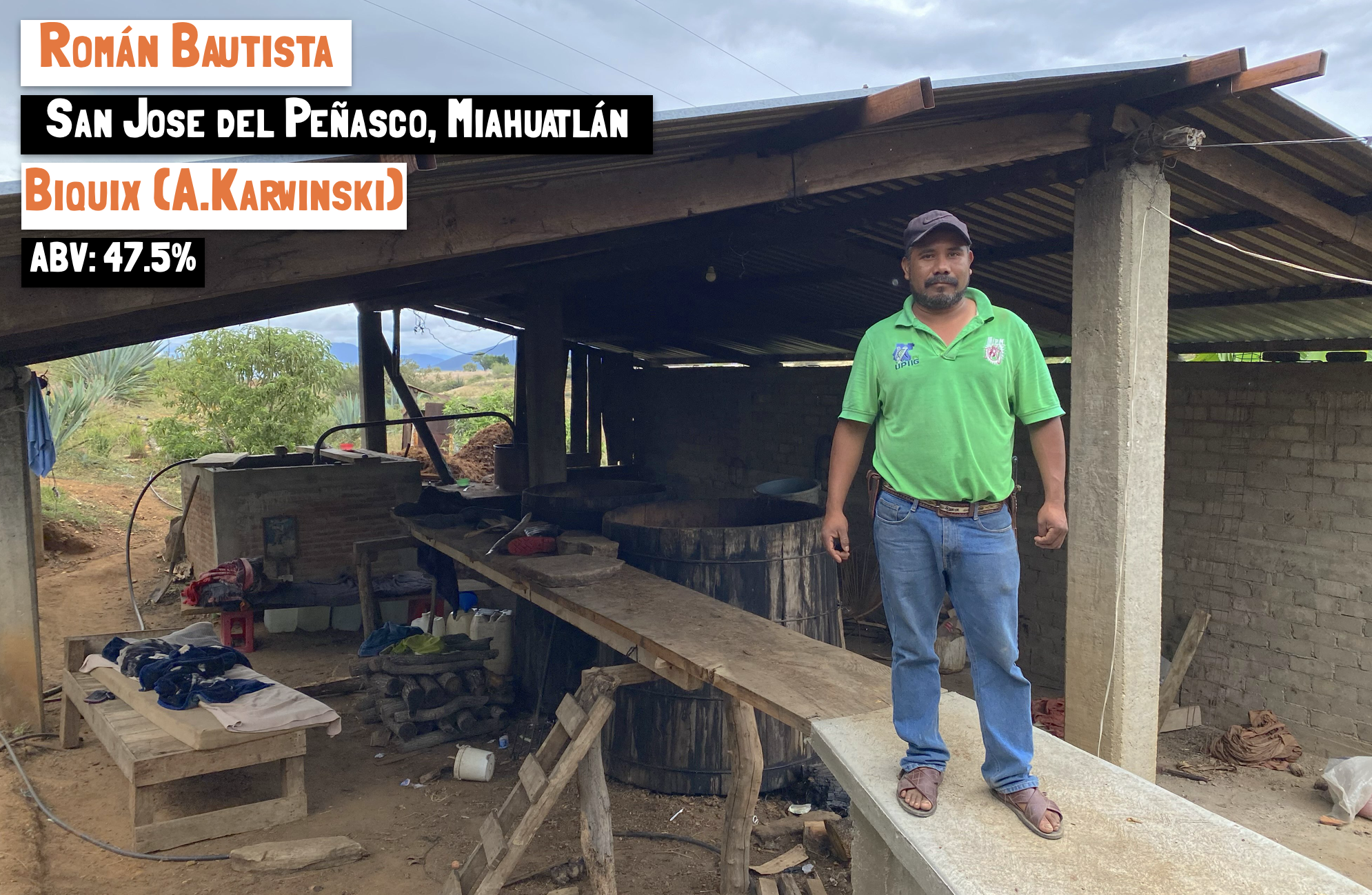 A man stood on a wooden platform in a make shift mezcal distillery in Mexico