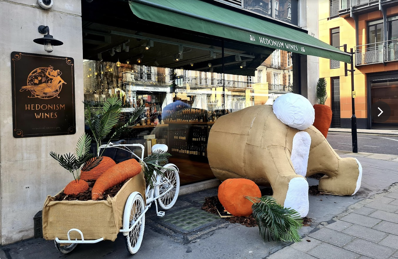 A giant rabbit falling through the shop window of Hedonism wines where a mezcal tasting is taking place hosted by the Sin Gusano project