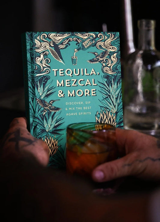 Tequila and mezcal book with a glass of mezcal in front