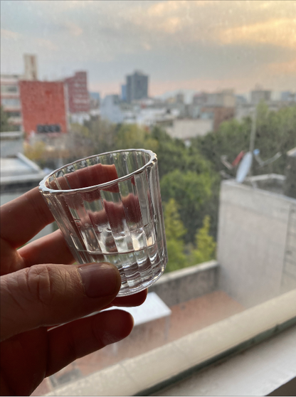 taking a sip of mezcal in London with the Vaso Veladora - Set of 2 mezcal glasses, available at Sin Gusano